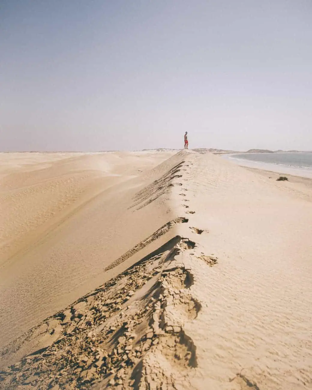 sugar-white sand dunes in Oman that end in the sea