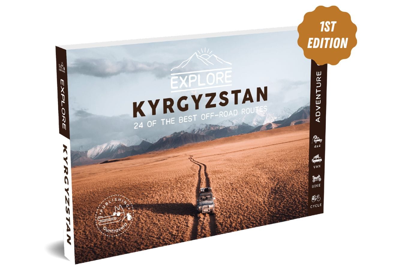 Cover of a travel guide entitled Explore Kyrgyzstan: The 24 Most Beautiful Trails with a photo of a vehicle driving on a dirt road through a vast mountainous landscape. A badge indicates 1st Edition.