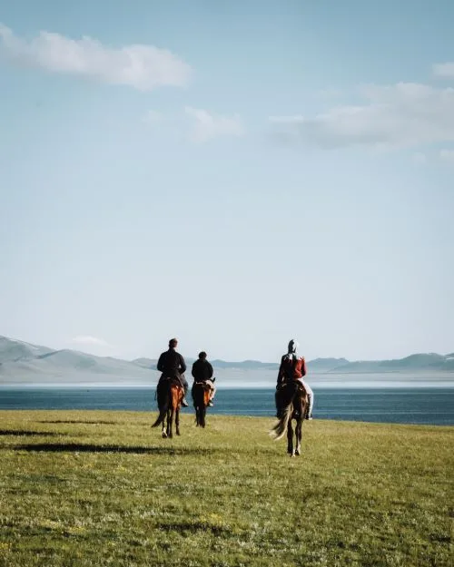 Bathing in Lake Song Kul with the trainer and his horse